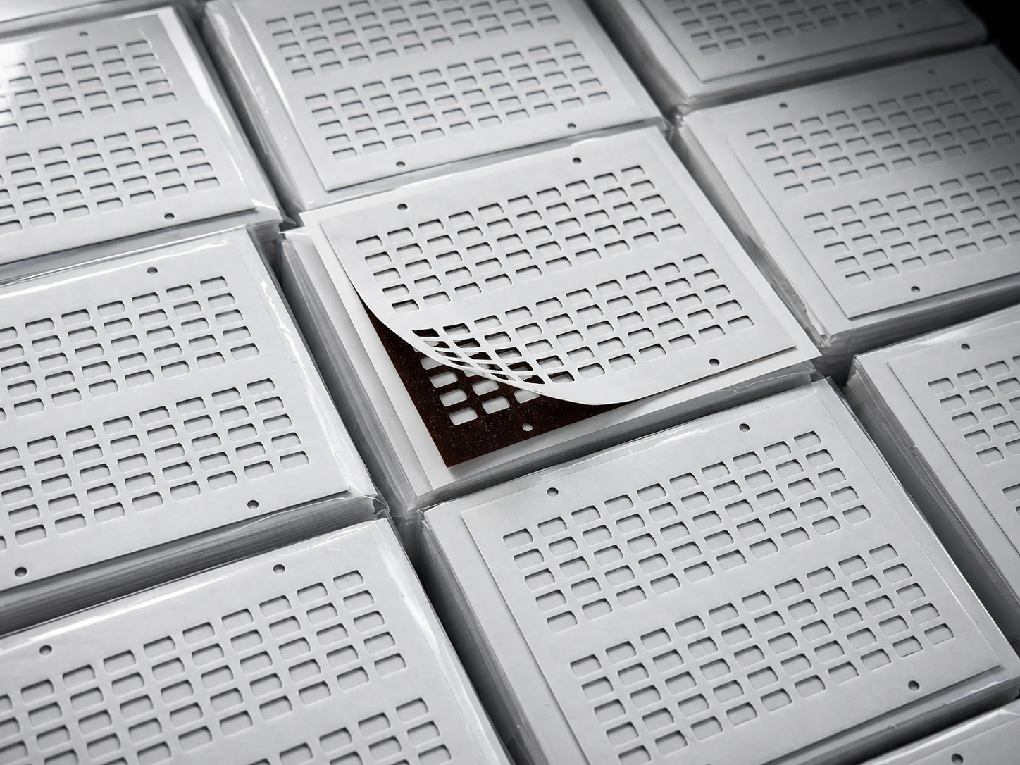 Laminated PI die-cut component structures with repeated cutouts and release layers